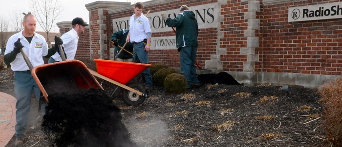 image of men laying new mulch